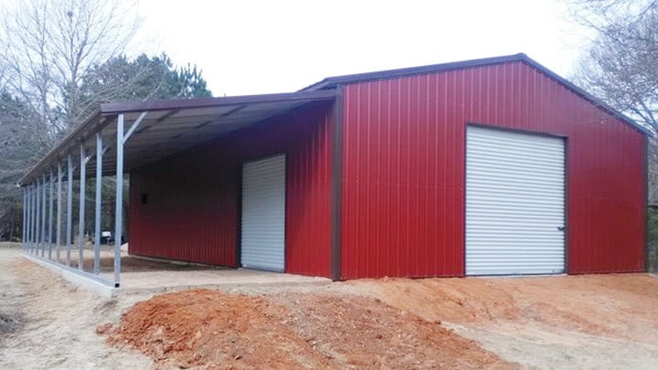 Red Texwin steel barn with a lean-to and white roll-up doors